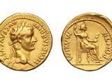 a gold coin with an image of a woman sitting on a chair