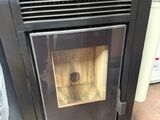 a black stove with a wood burning inside of it