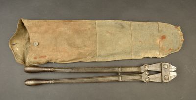 an old pair of tools sitting on top of a table next to a bag