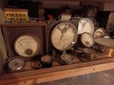 many different types of clocks displayed on a shelf