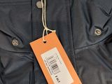 a close up of a jacket with a tag attached to it