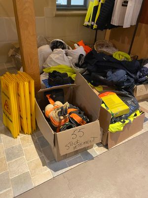 many boxes of clothes and other items on the floor