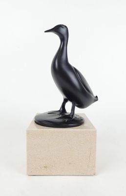sculpture représentant un oiseau noir posée sur un socle en marbre