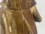 a gold statue of a bear with a hat on it ' s head