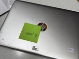 a laptop with a sticker on it sitting on a table