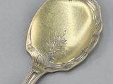 a silver spoon with a flower design on it