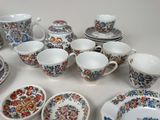 many cups and saucers sitting on a table