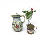 two vases that have flowers in them on the table