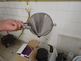 a man that is holding a funnel in his hand