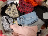 a basket full of clothes on a table with a red and white checkered table cloth