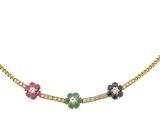 a gold necklace with multi colored flowers on a chain