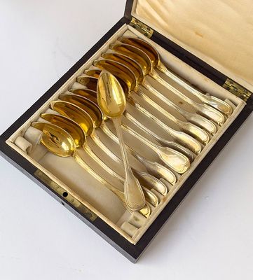 six spoons in a box on a white table