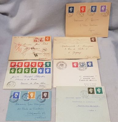 four envelopes with stamps and stamps on them sitting on a table
