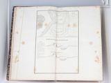 an open book with a map on it sitting on a shelf