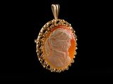 a close up of a pendant with a woman ' s face on it
