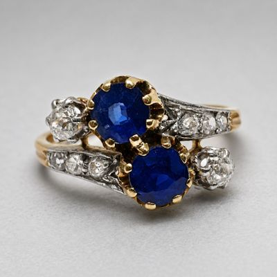 an image of a blue sapphire and diamond ring on a white surface