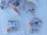 a lot of screws and other electrical components on a table