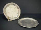 pair of silver plated trays on stand on black background