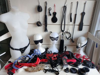 several mannequins are lined up on a table in front of a white wall