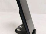 a cell phone that is on a stand on the table