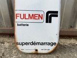 an old fuel can sitting on the ground in front of a building