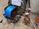 a hose and a reel on the ground next to a fire hydrant