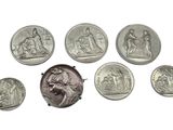 an image of a group of silver coins sitting on top of a white surface