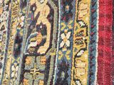an image of a close up of a colorful rug on a wooden floor