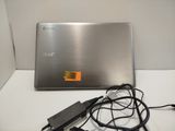 a silver laptop computer sitting on top of a white table