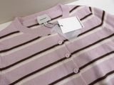 pink and brown striped sweater with tag on white table