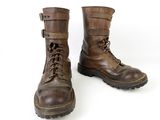 pair of brown leather boots with laces on them on a white background