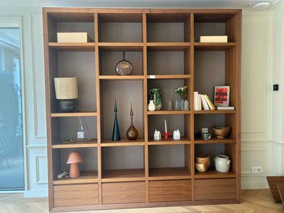 a wooden bookcase with many different items on it