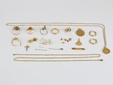 a collection of gold jewellery including rings, necklaces and earrings