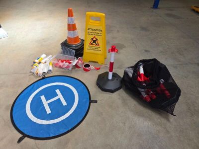 a blue sign on the floor next to a black bag