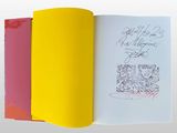 an open book with a drawing of two people on it
