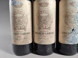 three bottles of wine sitting on top of a table next to each other