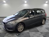 the bmw tourer is parked on a checkered tile floor