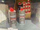 two cans of zippo on the shelf of a store