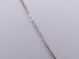 a close up of a silver chain on a white surface