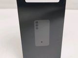 the back of a black box with a white sticker on it