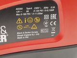 a close up of a red cordless driller on a white surface