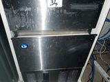 an image of a stainless steel refrigerator with a pink towel on top of it