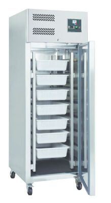 a close up of a freezer with four trays of food inside of it