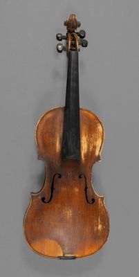 a close up of a violin with a bow on a gray background