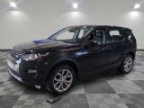 the black land rover is parked in a large room with checkered flooring