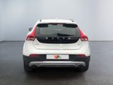 the rear end of a white and red car in a room