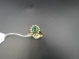 a close up of a ring with a green stone on it