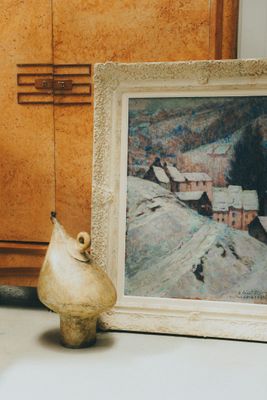 a picture of a painting and a vase sitting on a table
