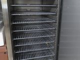 an empty stainless steel refrigerator in a kitchen