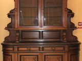 an image of a wooden china cabinet in a room